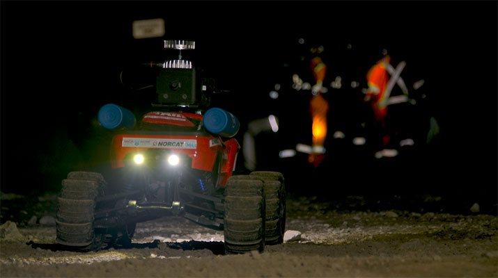 5G DeepTraxx in the foreground with an Emergency Response Team evacuating a simulated worker using SafeSight's powered Rescue Wheel in the background.
