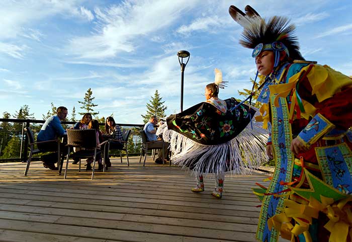 Indigenous dancers perform for hotel guests on the deck